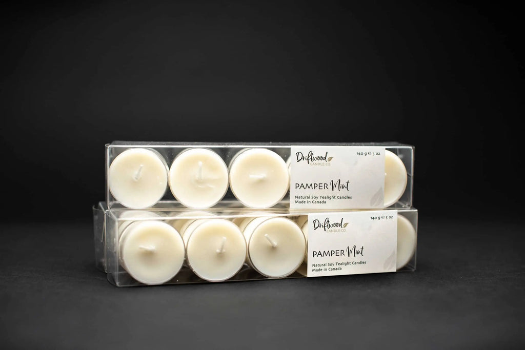 Two sets of clear boxes filled with soy tealights and labelled with Driftwood Candle Co. PamperMint scent label.