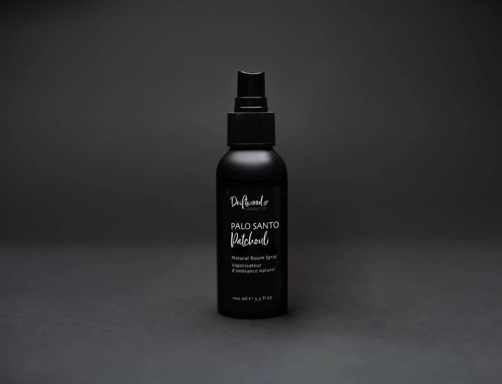 Palo Santo Patchouli room spray bottle displayed on a black backdrop