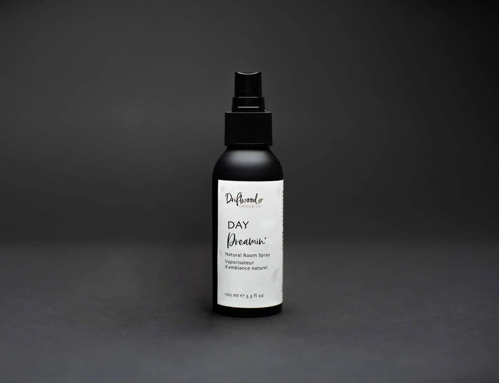 Black matted spray bottle labelled with Driftwood Candle Co. Day Dreamin' on black backdrop. 